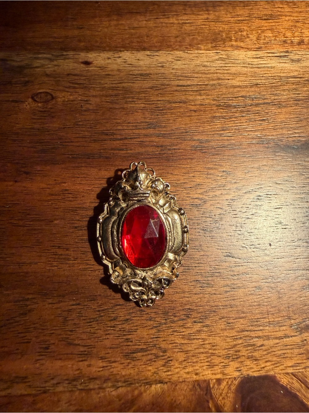 Vintage-Style Gold Brooch with Red Gem Accent
